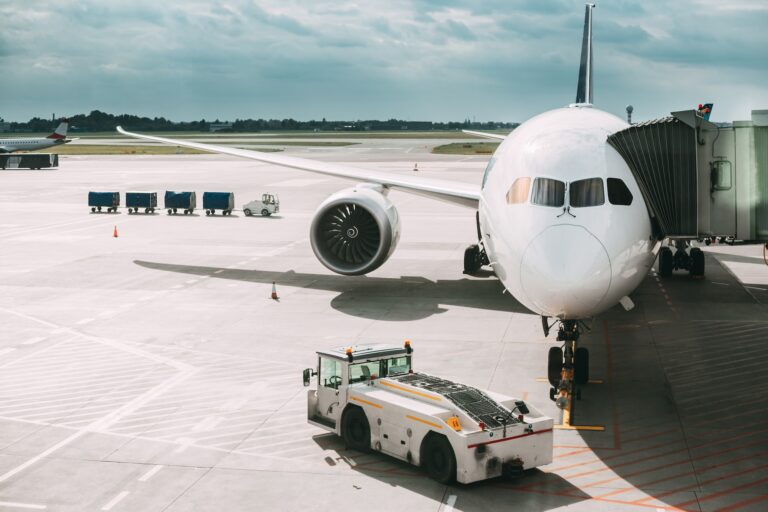 Aircraft Plane Boarding Passengers In Airport Terminal. Aircraft